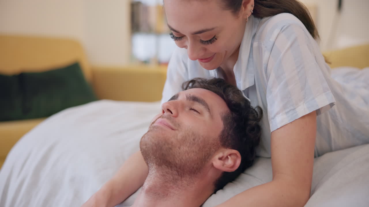Love, couple and kiss forehead in bedroom