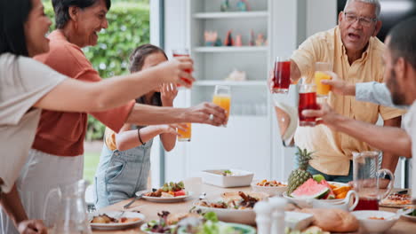 family, cheers and juice in home for lunch