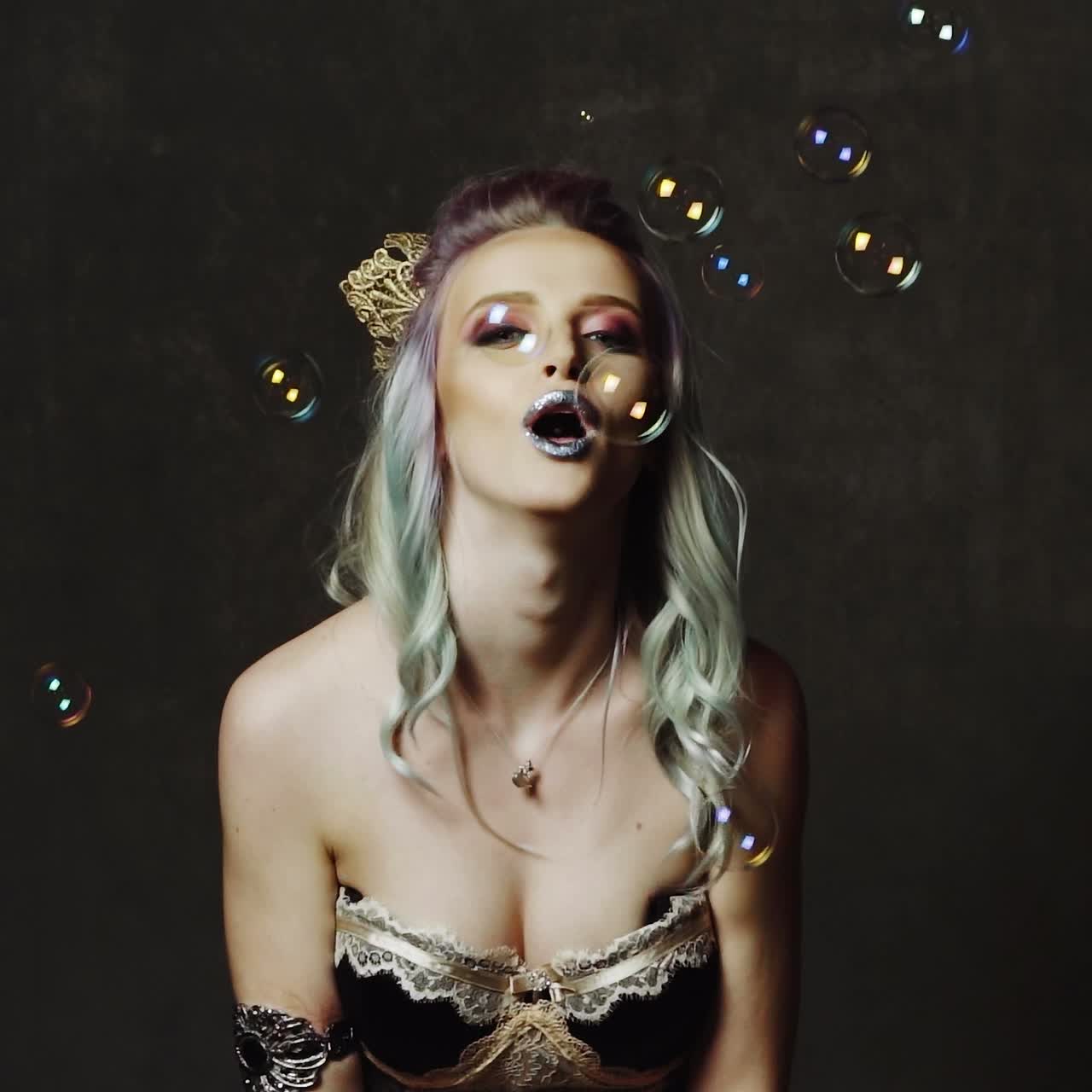 Blond blowing soap balloons