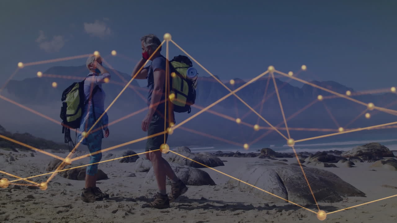 hiker couple wearing masks exploring beach, interacting with glowing network overlay health tech
