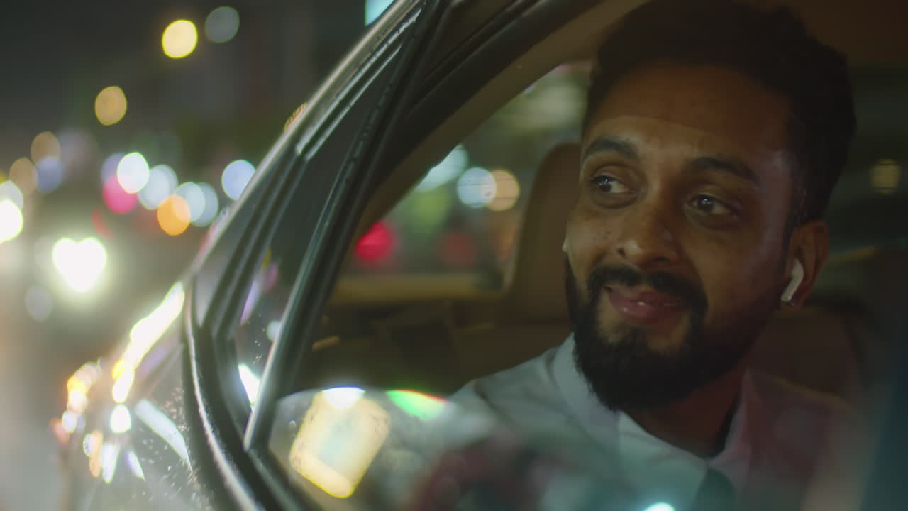 Businessman Riding in Car and Enjoying Night City