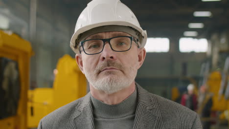 portrait of senior engineer at heavy equipment factory