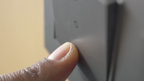 finger pressing a light switch