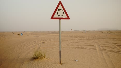 desert road with roundabout sign