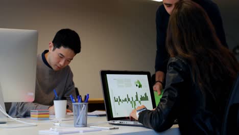 business colleagues interacting with each other at desk 4k