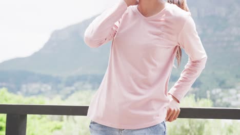 slow motion video of biracial woman wearing pink long sleeve shirt with copy space