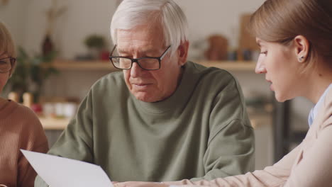 senior couple having meeting with financial consultant at home