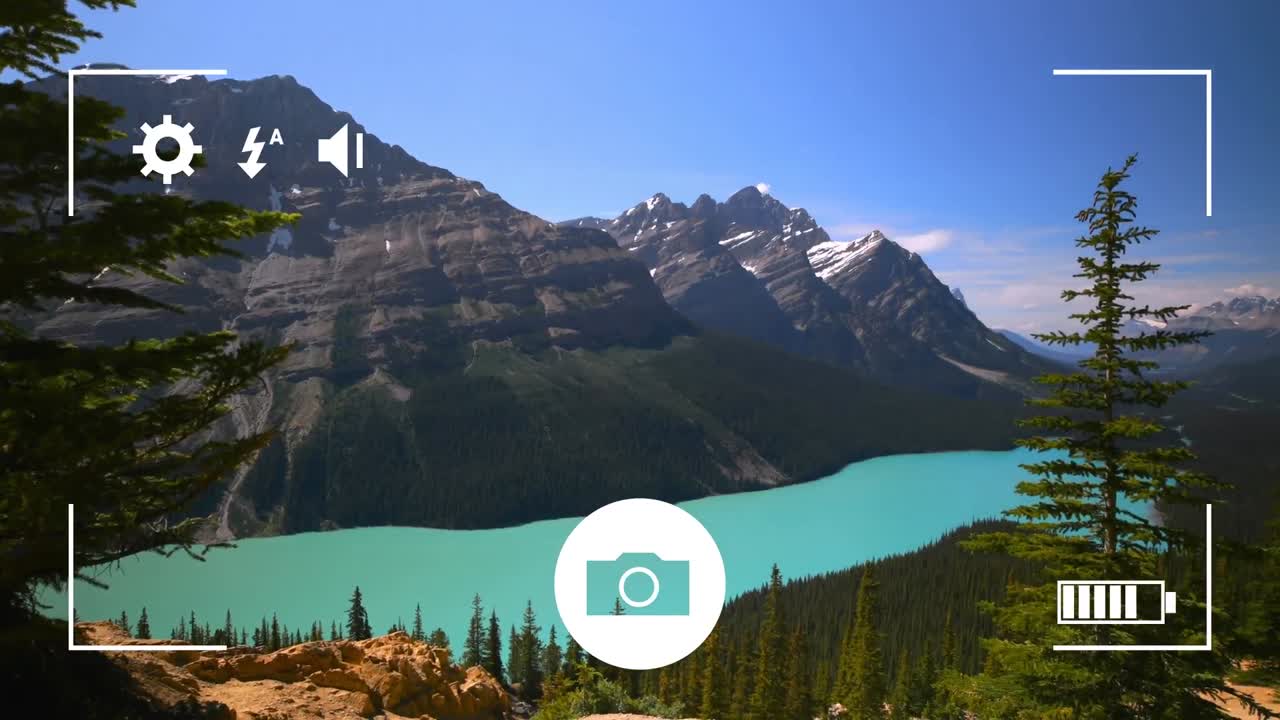Digital camera interface against landscape with woods, lake and mountains