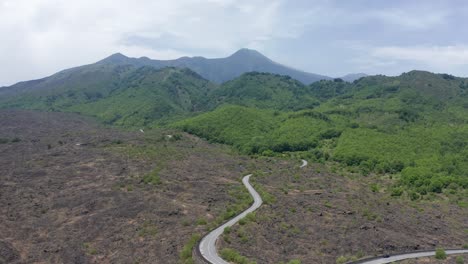 drone flying above the road to etna volcano in italy