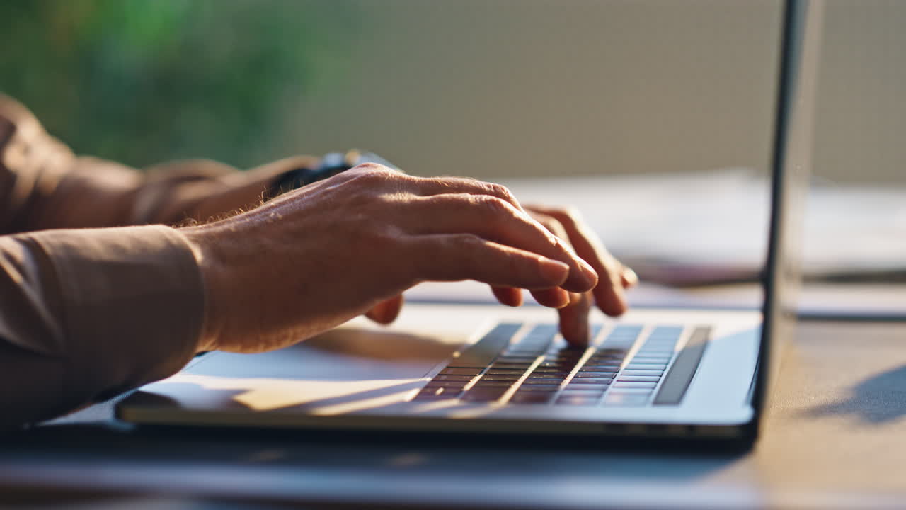 Unknown writer typing keyboard laptop at table close up. Hands pressing buttons