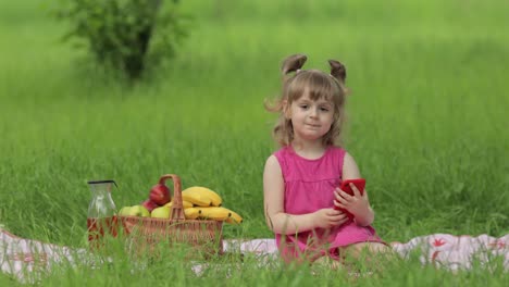 Weekend-at-picnic.-Girl-on-grass-meadow-makes-selfie-on-mobile-phone.-Video-call,-blog,-play-games