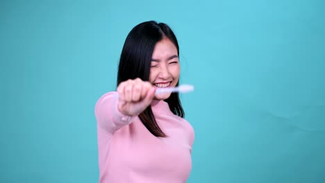 푸른 스크린 배경에 정형 치과 장치를 착용 한 미소 짓는 아시아 여성. 치과 관리와 건강한 치아.