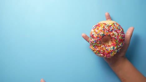 child holding a colorful donut