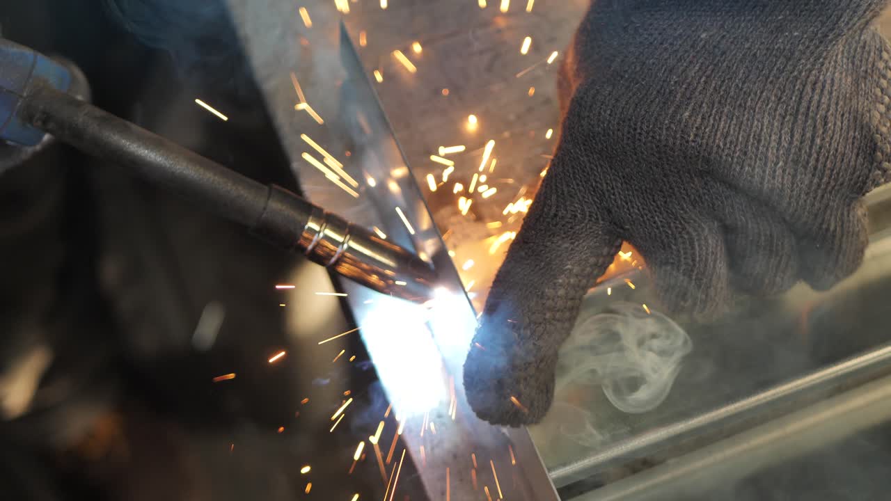 Close-up work with metal steel and iron using a welding machine