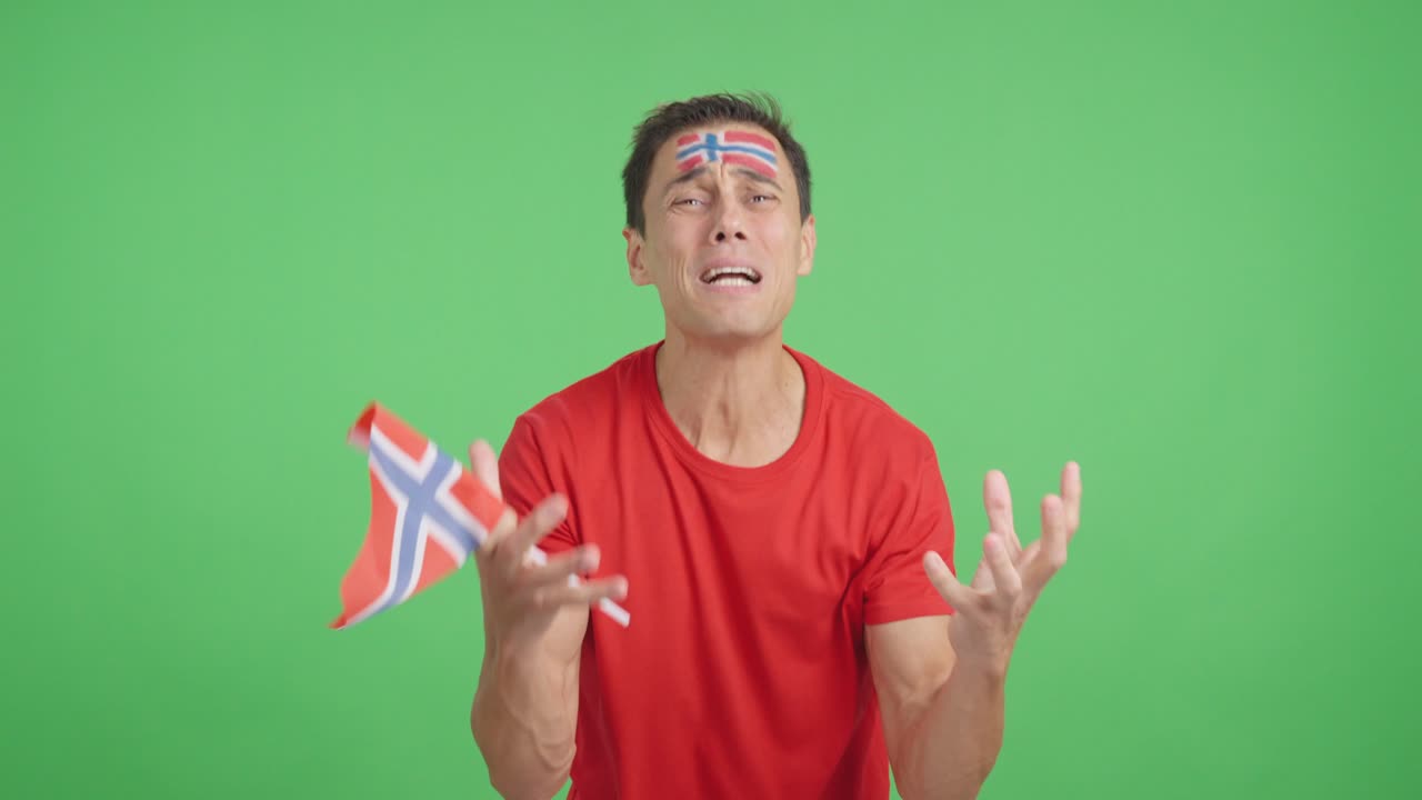 Man cheering for Norway during a match that is lost