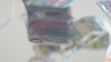 Euro-bills-falling-in-slow-motion-on-a-white-background