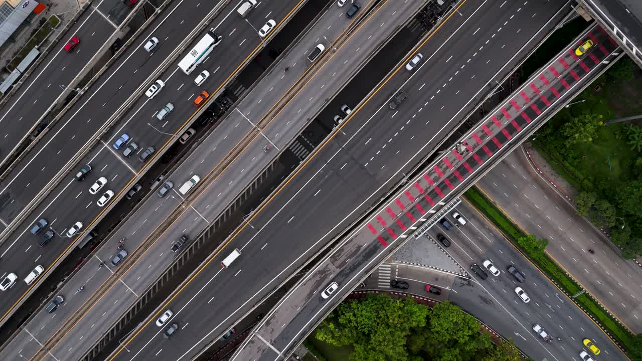 Top down birds eye view cars driving along complex system of roads and highway