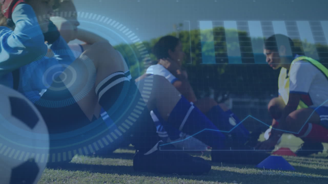 Six female soccer players crunching on grass field showing fitness HUD target overlays, bar charts