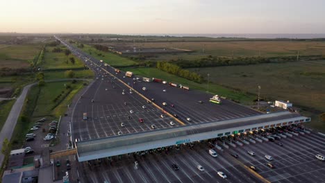 a drone shot made above the hudson toll in buenos aires, argentina, where cars are approaching the toll and going through