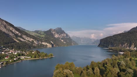 drone pulls back over serene lake near walensee, wessen, amden, kanton st