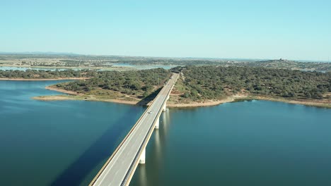 still shot of a beam bridge projecting a shadow in the water