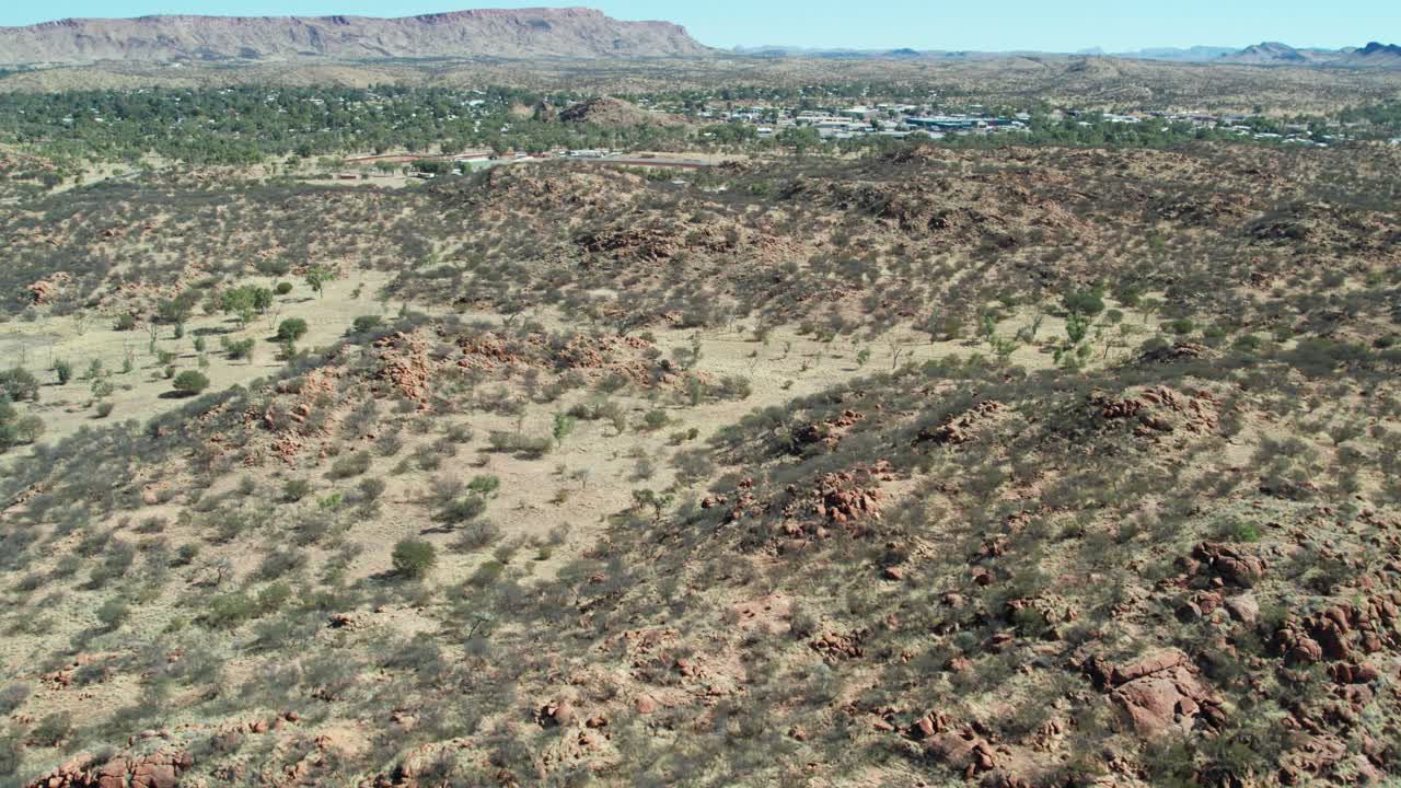 Aerial view of dry rocky landscape north of Alice Springs, Mparntwe. Northern Territory, Australia. August 2022.