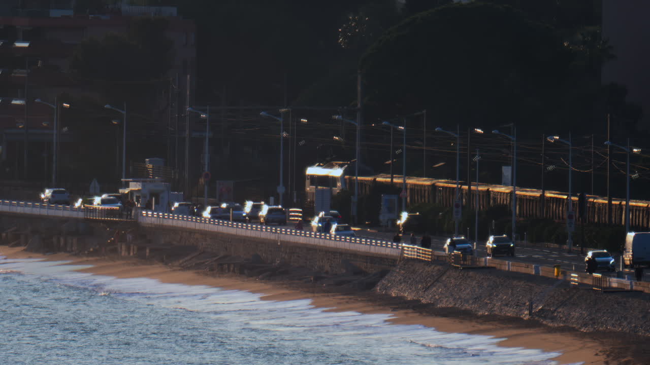Cannes, France - March 13, 2025: Distant view of a train moving on the rails near the beach