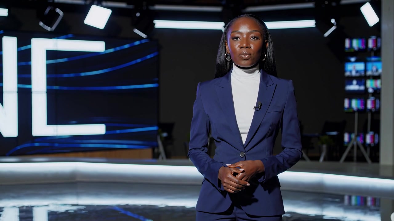 Professional Black Woman Presenting News in Modern Studio