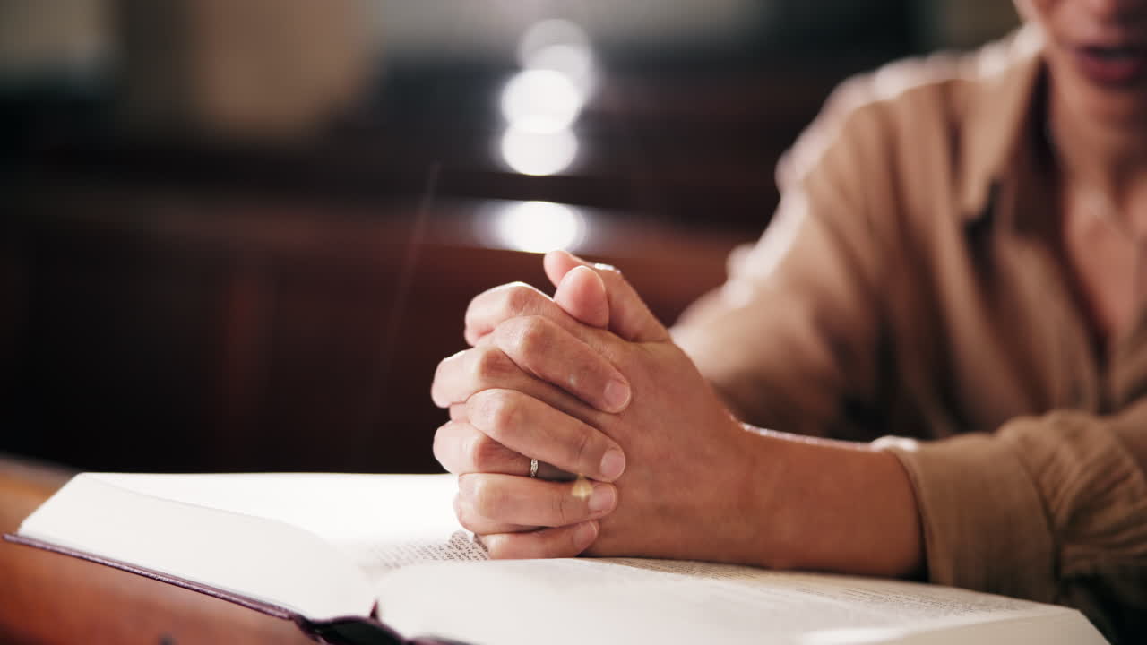 Woman praying with Bible in church