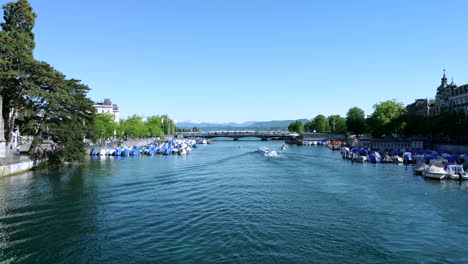 boats anchored on banks of limmat river on sunny day, zurich. static