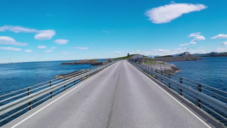 driving a car on a road in norway atlantic ocean road or the atlantic road (atlanterhavsveien) been awarded the title as (norwegian construction of the century).