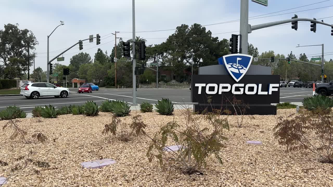 Top Golf Sign From A Moving Car In The Parking Lot. Golfing Entertainment Venue In Los Angeles.