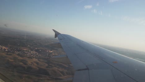 view of the wing of a plane while descending