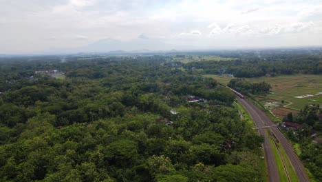 Aerial-view-of-a-train-running-on-rails-in-the-middle-of-countryside