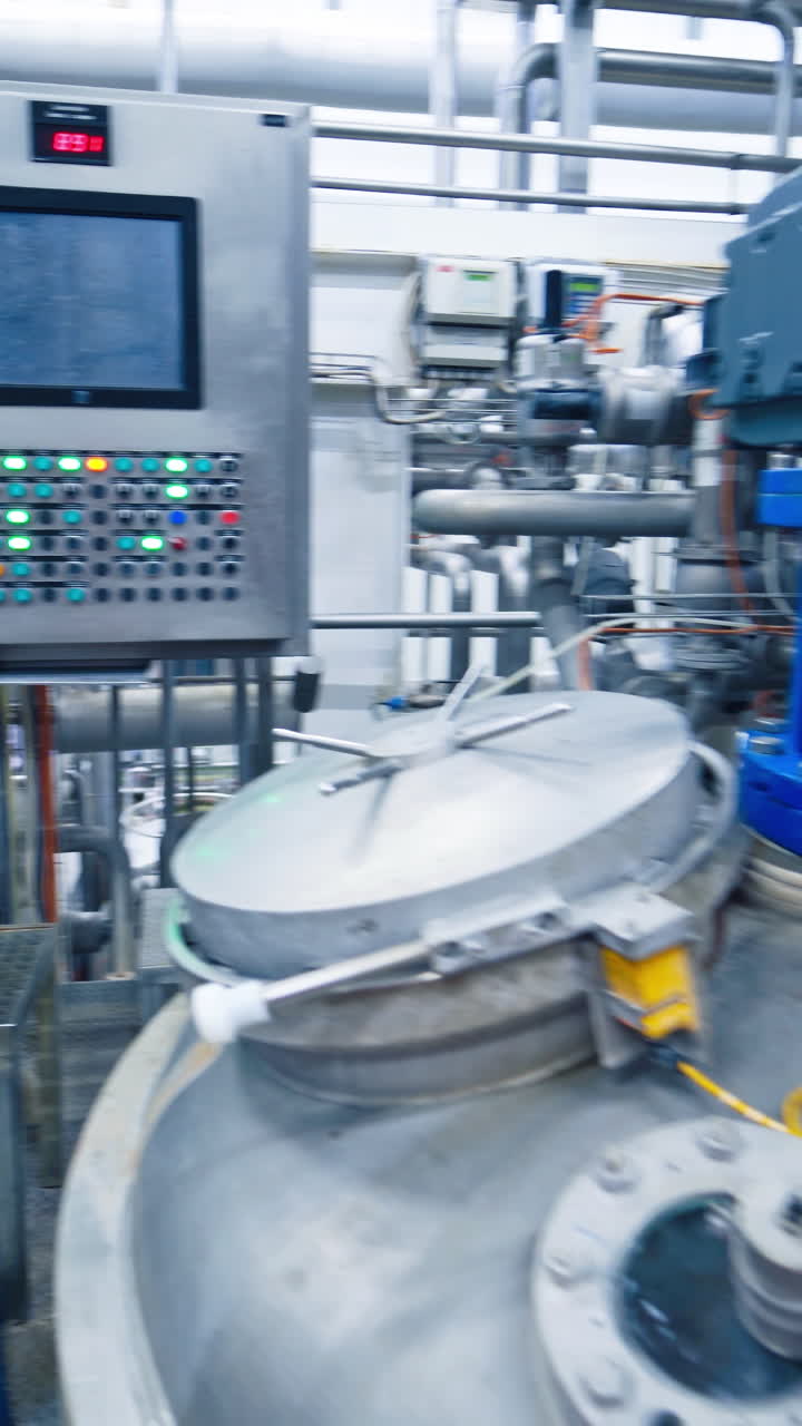 Equipment at dairy plant. View of the interior of a milk factory. Vertical video