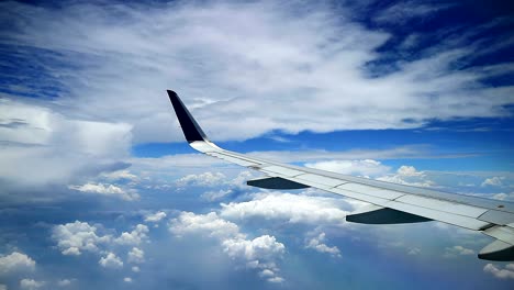 dramatic cloudy bluesky view from commercial airplane windows