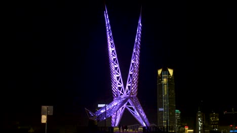 oklahoma city sky dance bridge over expressway with skyline at night okc