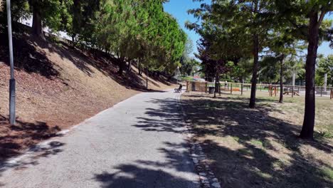 drone footage from a bicycle lane through a small park