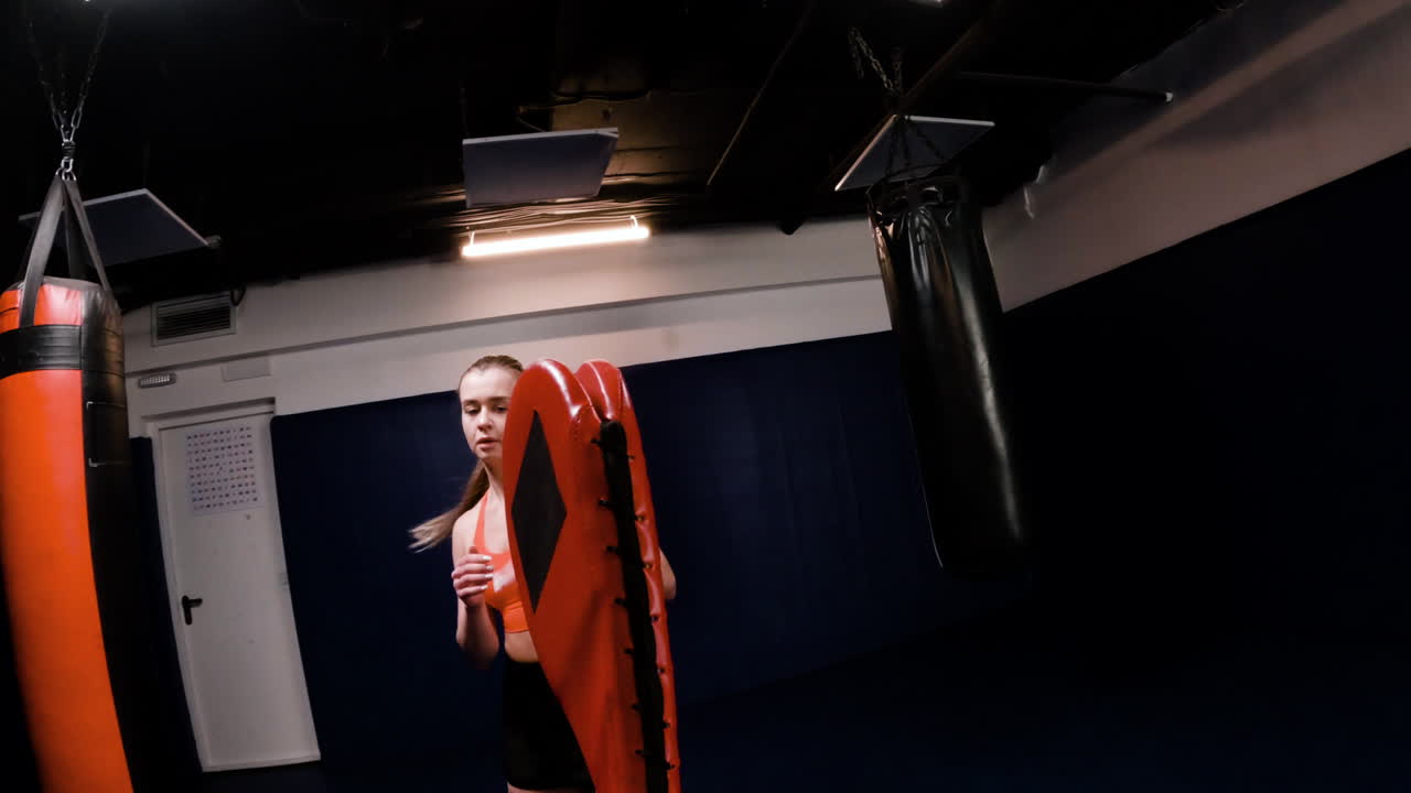 Woman practicing kickboxing techniques