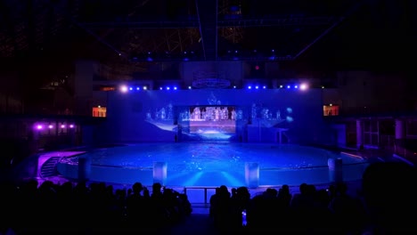 colorful light show on a large indoor stage in tokyo with projections and a futuristic atmosphere