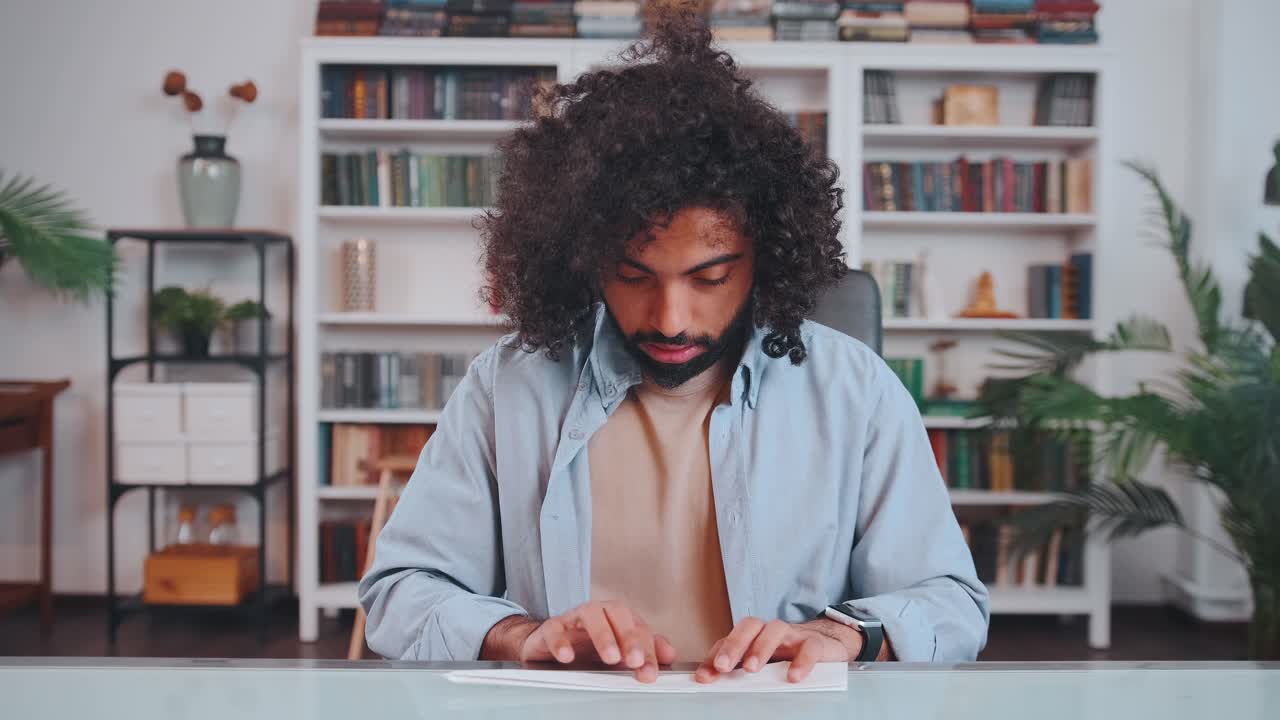 Young arabian man amuses himself by launching paper airplane during work