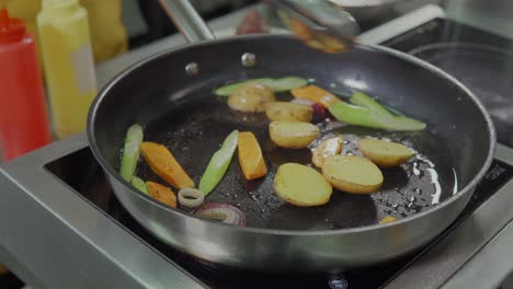 frying vegetables in a pan