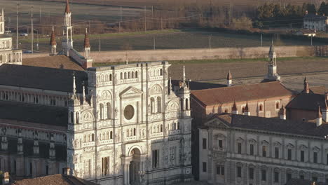 Aerial-shot-of-Certosa-di-Pavia-cathedral-a-historical-monumental-complex-that-includes-a-monastery-and-a-sanctuary