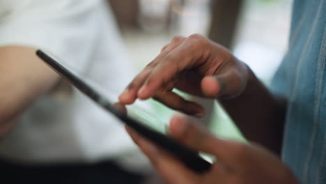close shot of hand moving across foggy touchscreen device surface cinematic motion capturing hazy visuals fingertip tracing shapes through misted glass ambient light reflections blur evoking mystery