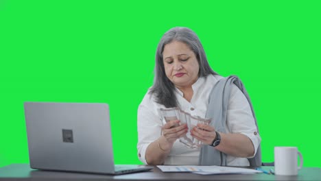 Happy-Indian-senior-businesswoman-counting-money-Green-screen