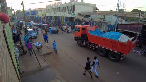 aerial view of african colorful outdoors serekunda market with passing by traffic