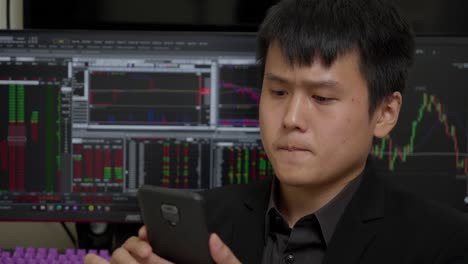 elegant chinese man happy to see income from investing in stock market