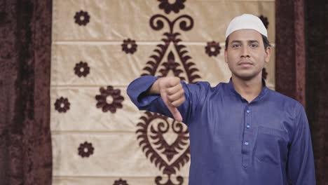 muslim man showing thumbs down with copyspace