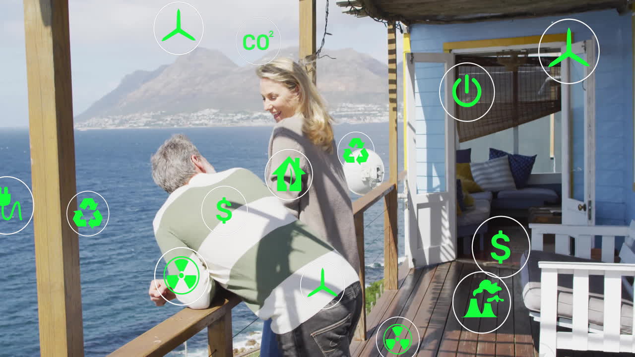 Man leaning railing with woman smiling behind him on deck, featuring floating eco icons for energy