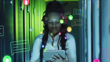 animation of social media icons over african american woman working in server room